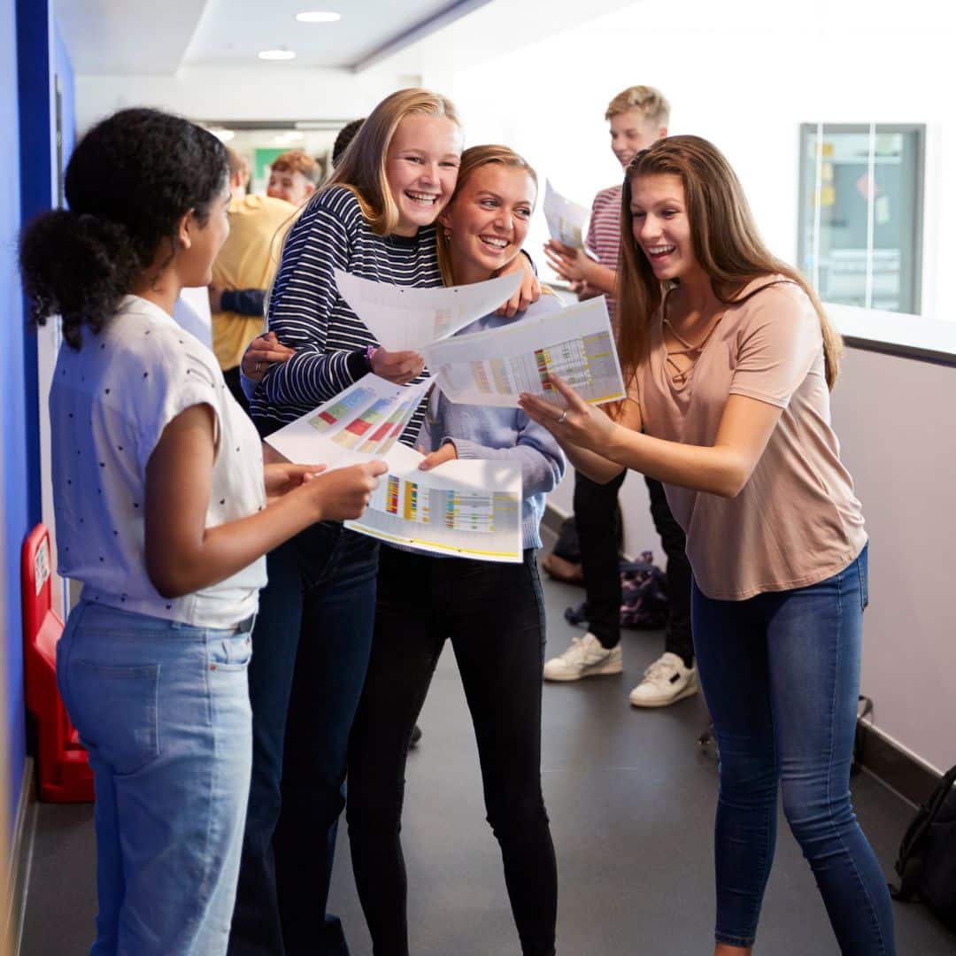 A group of students sharing news of their A Level results.